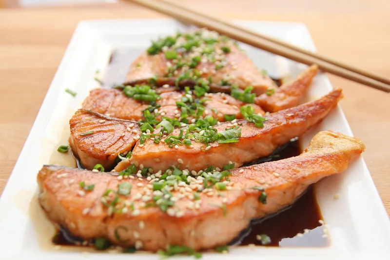 Pieces of cooked salmon scattered with chives