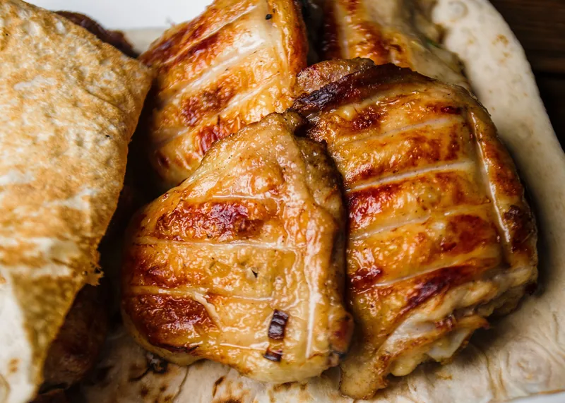 Glossy browned chicken breasts close up, the glaze catching the light