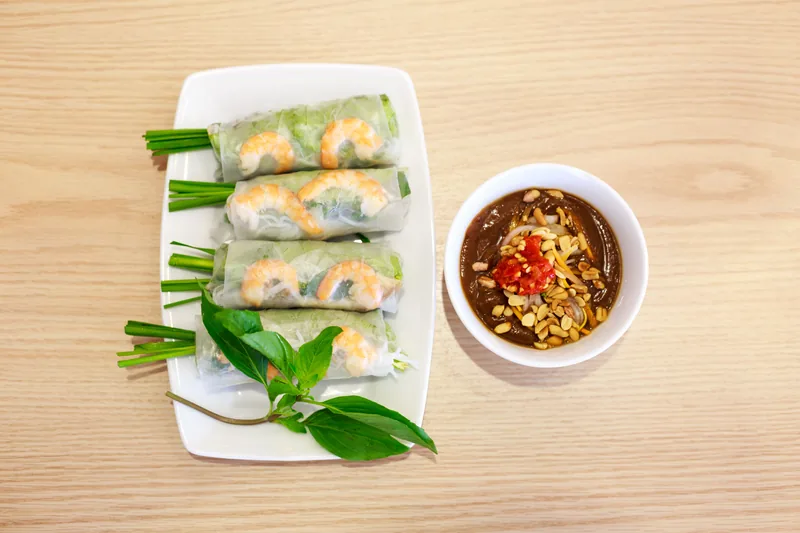 Fresh rice-paper spring rolls with a bowl of dipping sauce