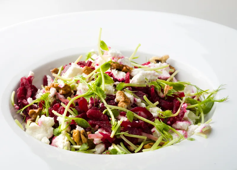 Beet salad with crumbled feta, walnuts and micro greens