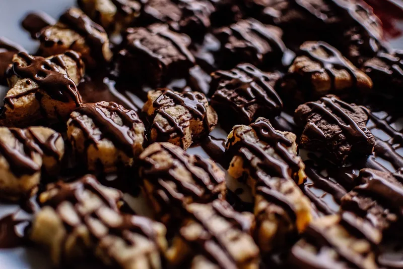 A tray of chocolate cookies finished with drizzled chocolate