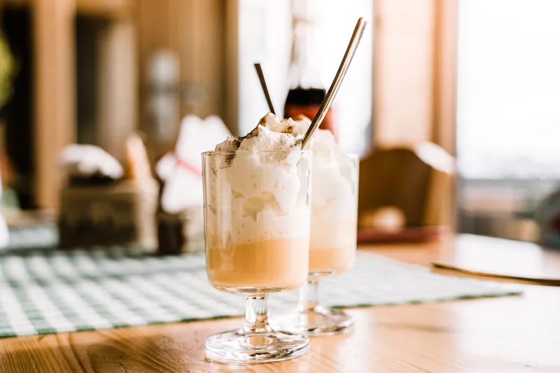 Two tall glasses of a creamy blended drink