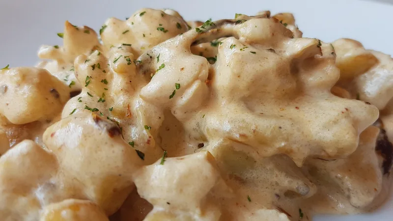 Small potato dumplings heaped in a thick cream sauce flecked with herbs