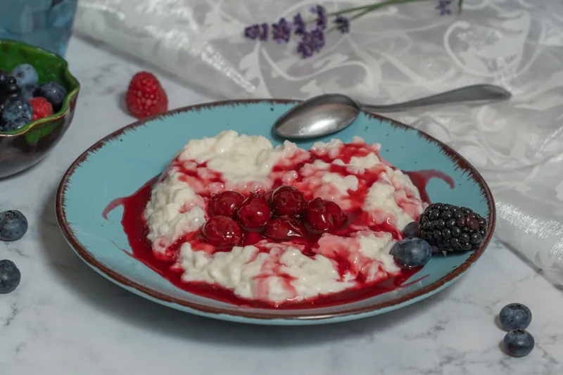 Rice pudding with cherry sauce and fresh berries
