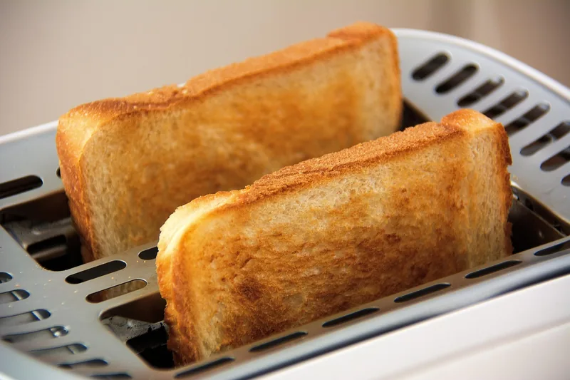 An air fryer basket during cooking