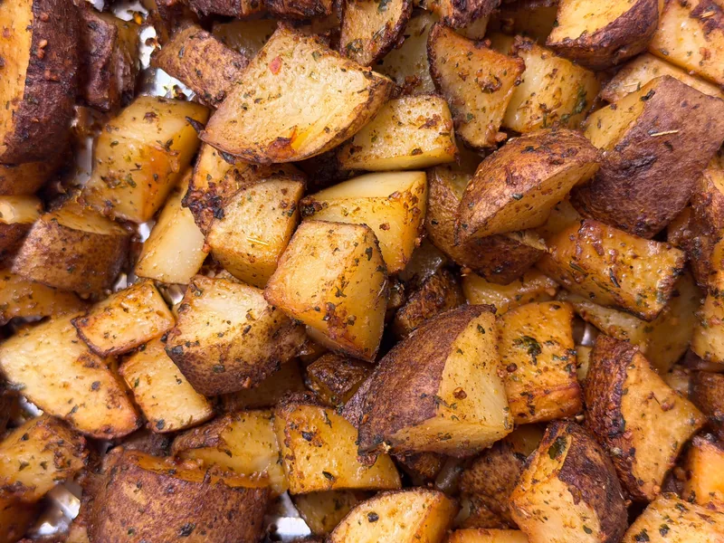 Crisp roasted potato cubes scattered with herbs