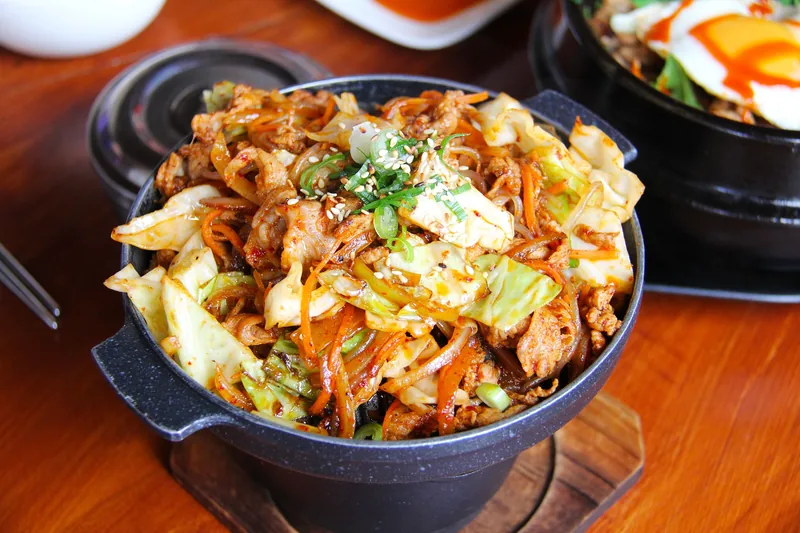 Stir-fried pork and cabbage in a black pan