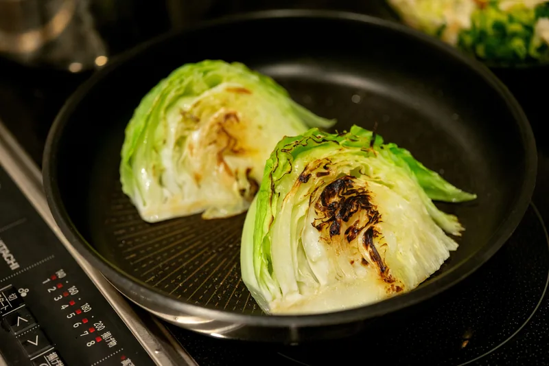 Cabbage wedges seared and browned in a griddle pan