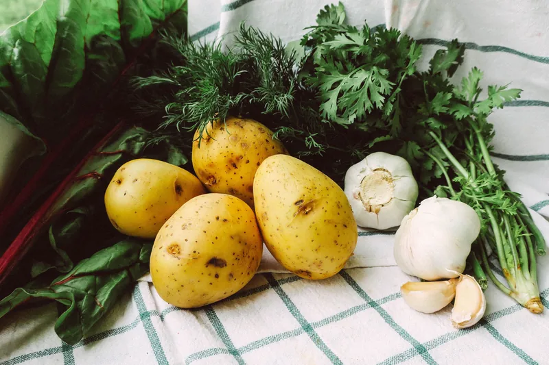 Raw potatoes with garlic and fresh herbs