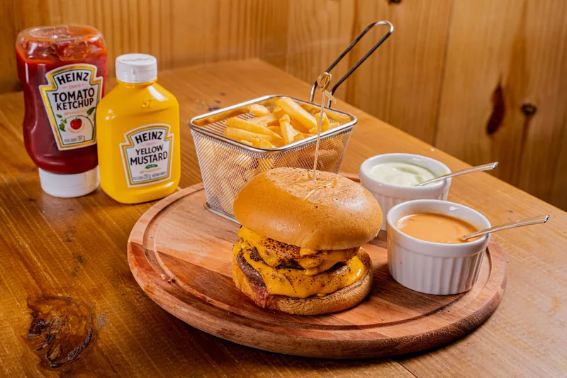 A ramekin of burger sauce beside ketchup and mustard